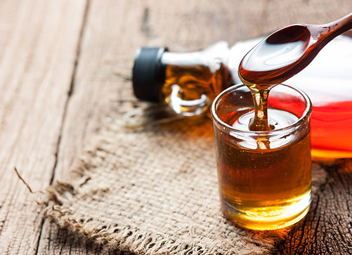 Maple syrup being poured into a glass